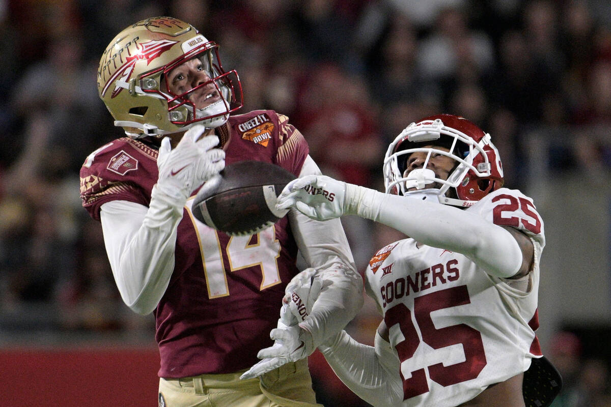 FILE - Florida State wide receiver Johnny Wilson (14) makes a reception while defended by Oklah ...