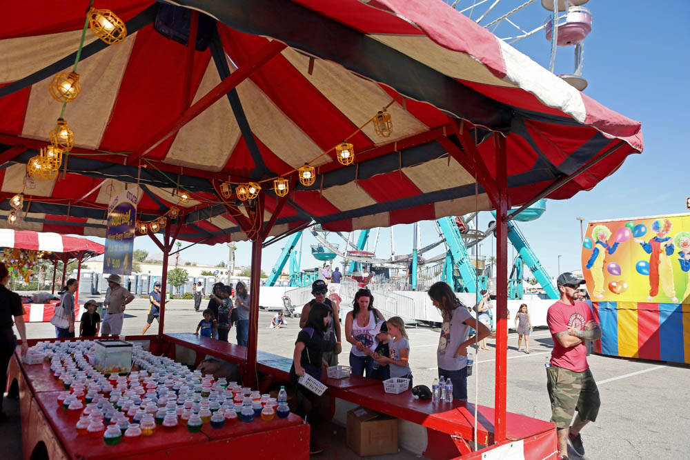 Visitors of the Great American Foodie Fest play a carnival game at the festival at the Sunset S ...