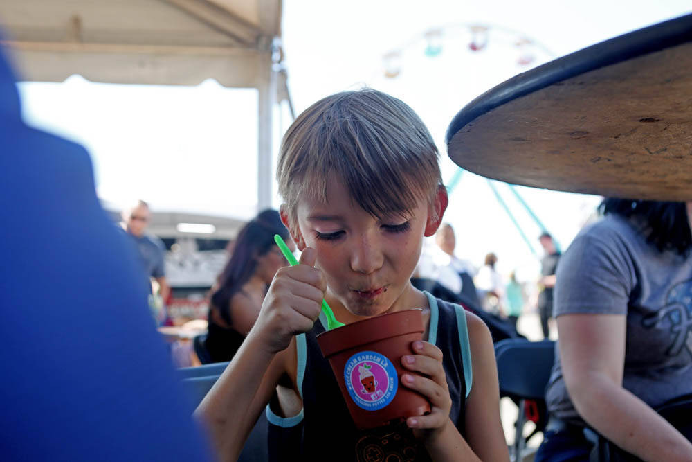 Lloyd Webster-Parks, 7, eats a dirt cup from the vendor, Ice Cream Garden LA, at the Great Amer ...