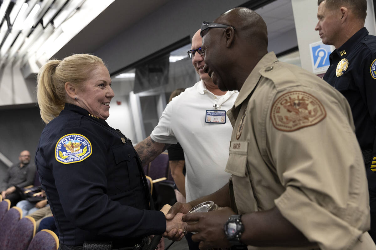 Newly appointed police chief Hollie Chadwick greets fellow officers after her swearing in cerem ...