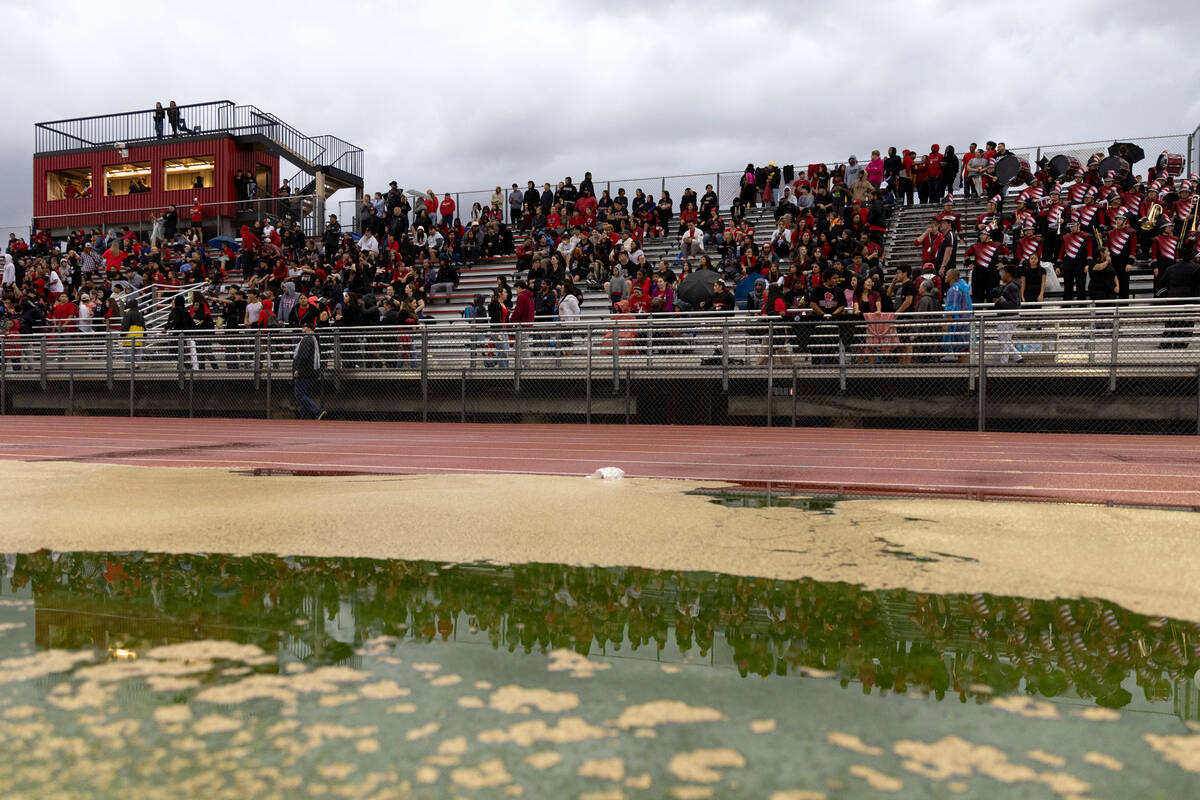 Las Vegas fans brave the rain for a high school football game against Rancho at Las Vegas High ...