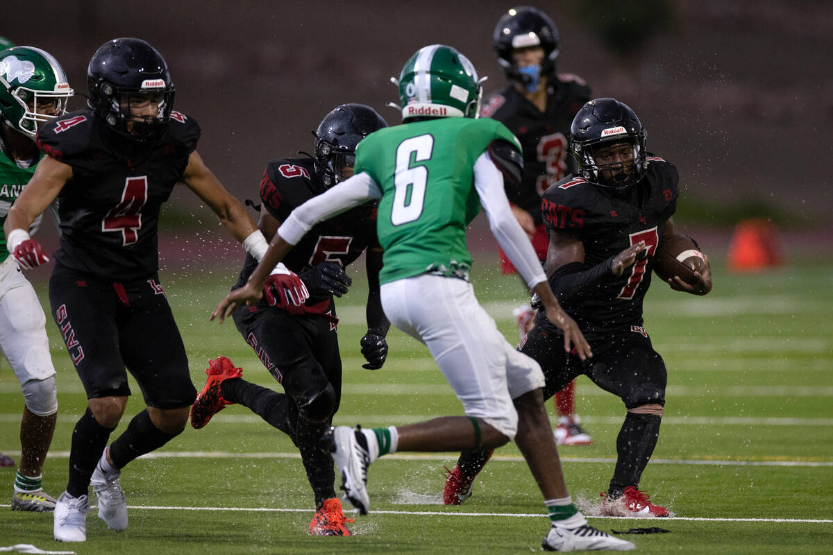 Las Vegas running back Torrell Harley (7) runs the ball while Rancho's Devon Jenkins (6) gets i ...