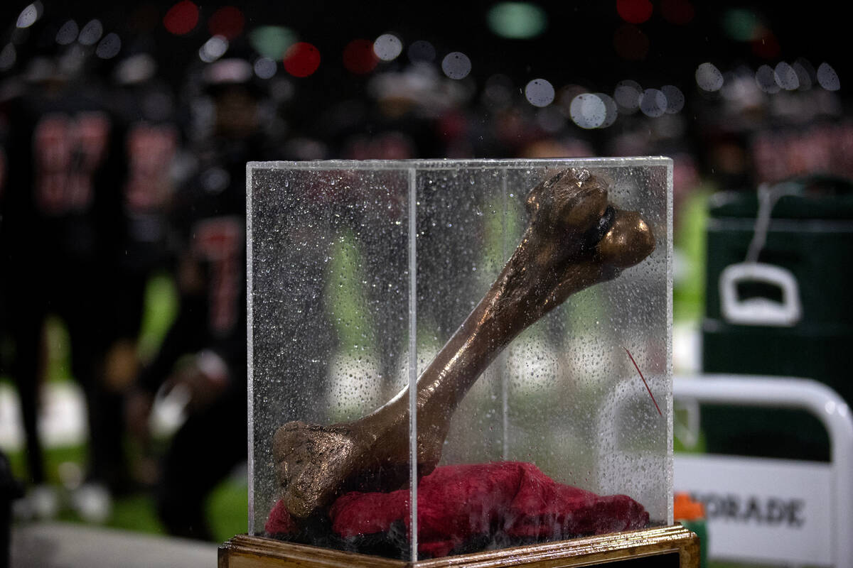 The trophy for a high school football game between Rancho and Las Vegas is displayed on the fie ...