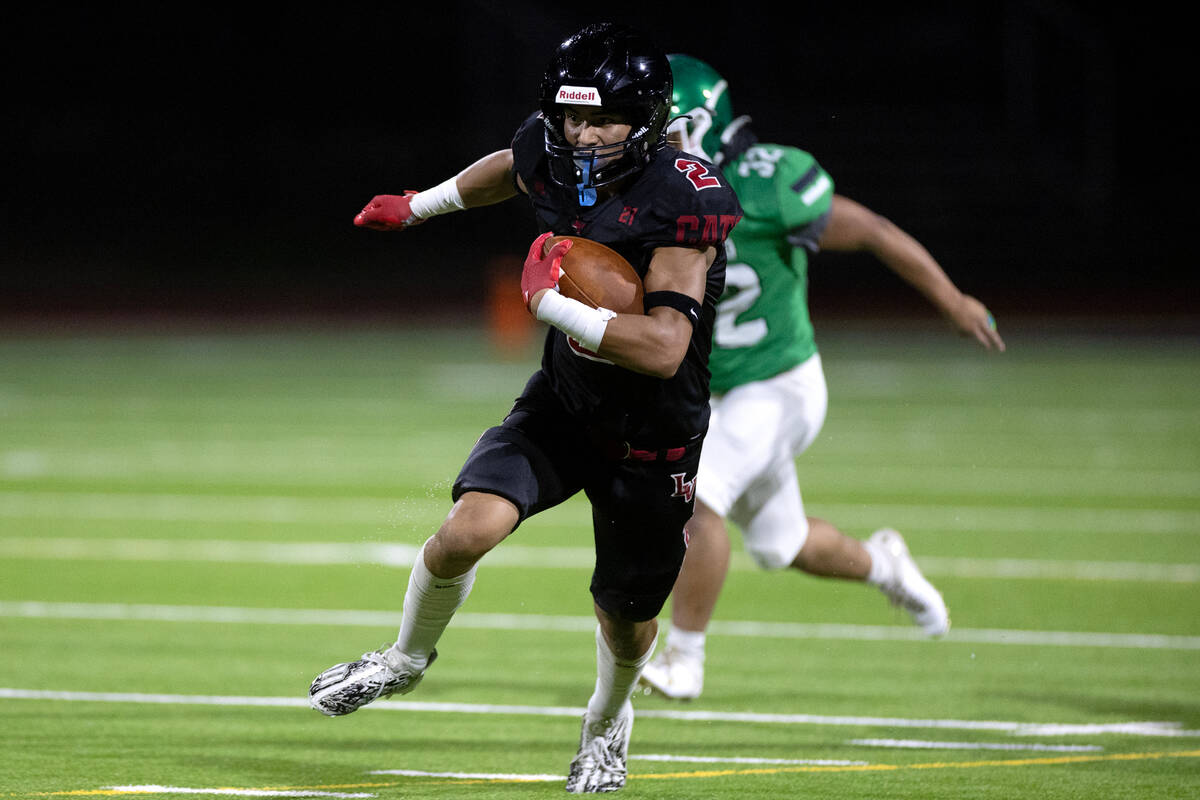Las Vegas wide receiver Tommy Vibabul (2) runs for the long haul while Rancho wide receiver Abe ...