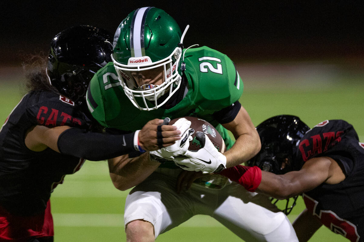 Rancho's Kamarie Thorns (21) is tackled by Las Vegas’ Kawika Lopez (8) and Lalit Kumar ( ...