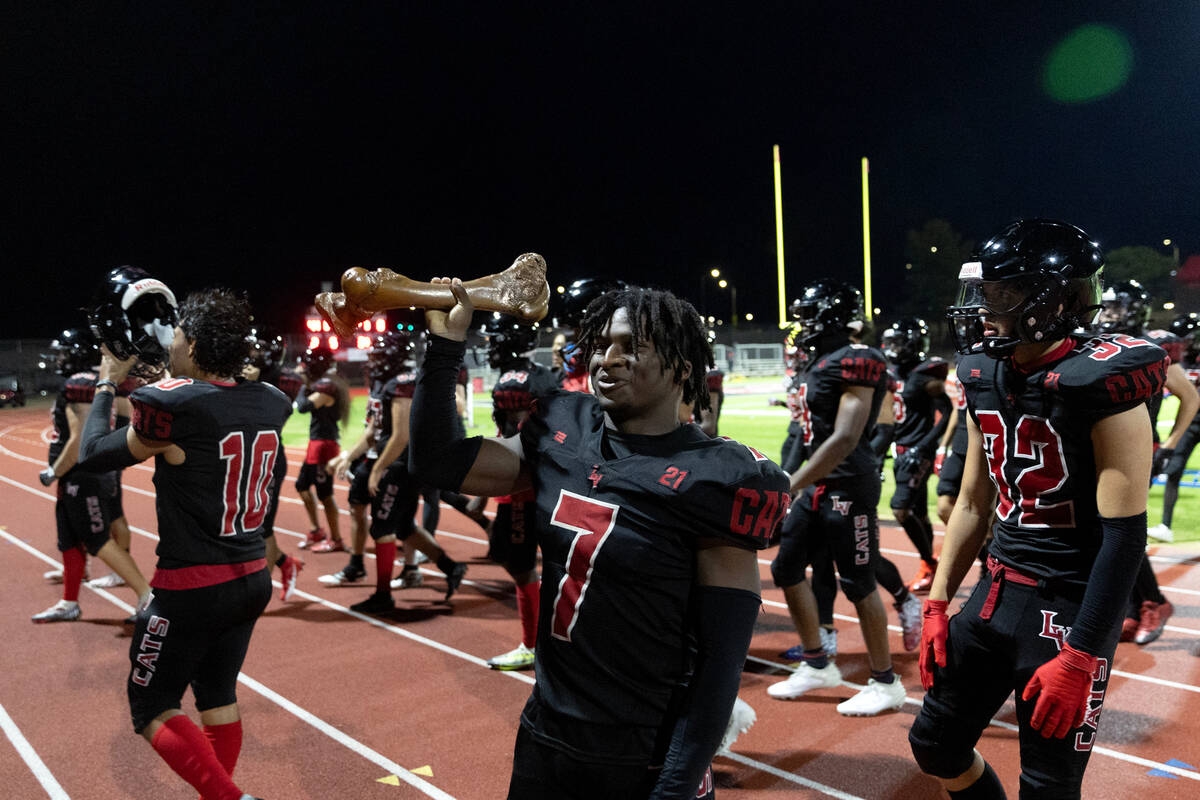 Las Vegas running back Torrell Harley (7) holds up his team’s trophy after winning a hig ...