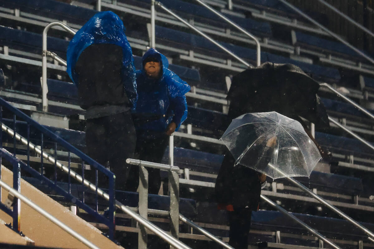 Fans wait for the rain to mellow out before the beginning of Bishop Gorman’s game agains ...