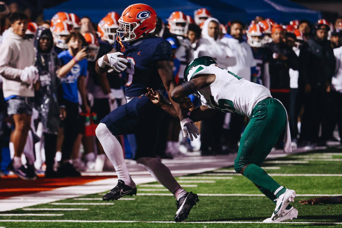 Bishop Gorman tight end Elija Lofton (9) keeps the ball in his possession as Miami Central line ...