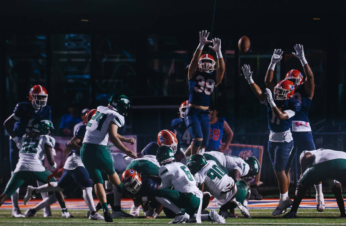 Bishop Gorman football players attempt to stop a field goal by Miami Central kicker Kristian H ...