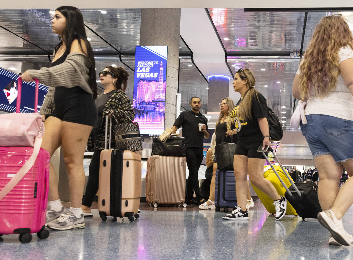 Arriving passengers head to baggage claim area at Terminal 1 of Harry Reid International Airpor ...