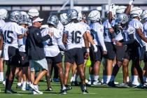 Raiders head coach Josh McDaniels talks with wide receiver Jakobi Meyers (16) during ...