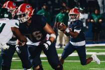 Bishop Gorman quarterback Micah Alejado (12) looks to pass the ball to a teammate during a game ...