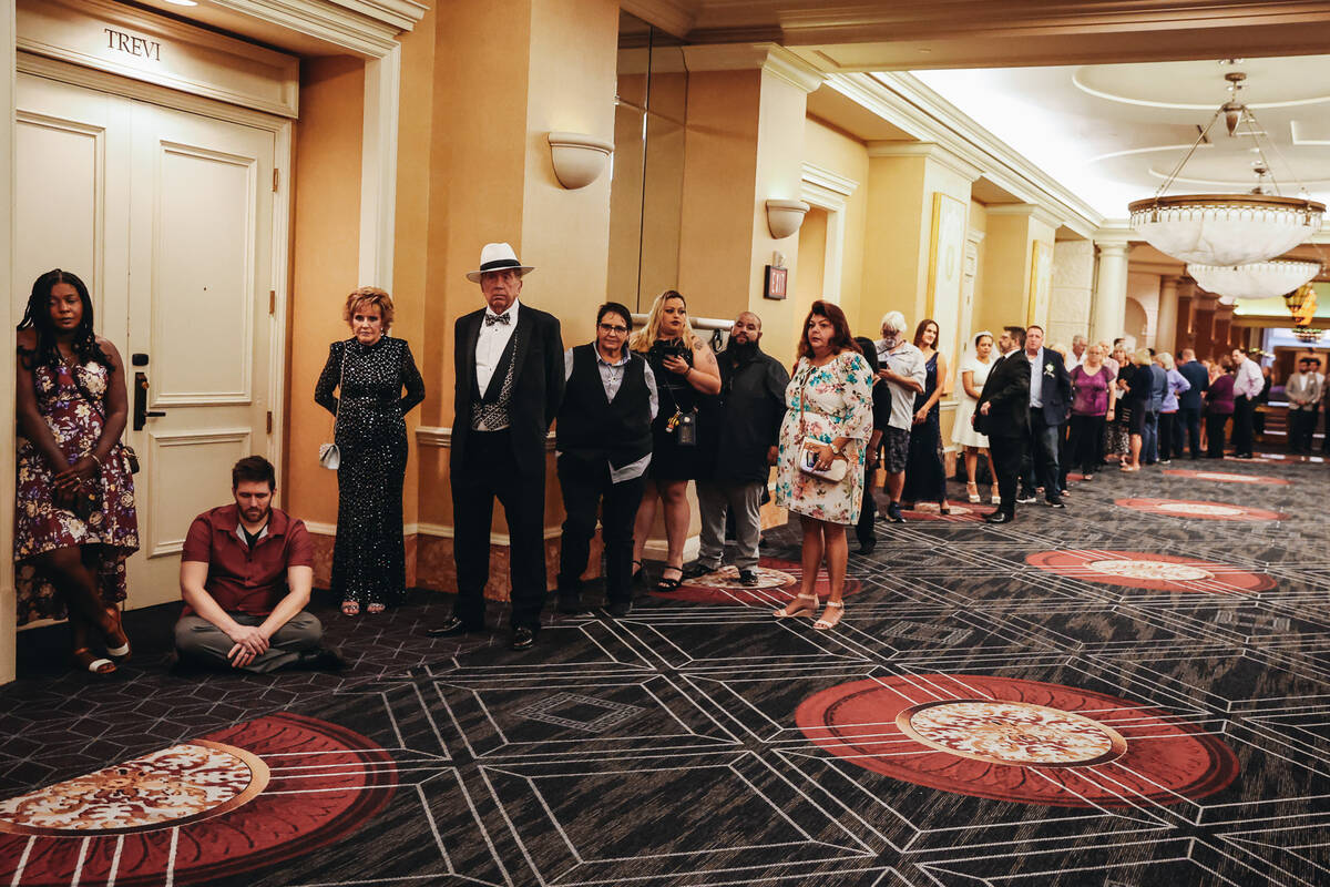 Couples wait to enter the Octavius Ballroom to renew their vows during a ceremony at Caesars Pa ...