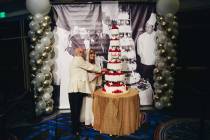 A couple pretends to cut a cake at a vow renewal ceremony for 250 couples at Caesars Palace on ...