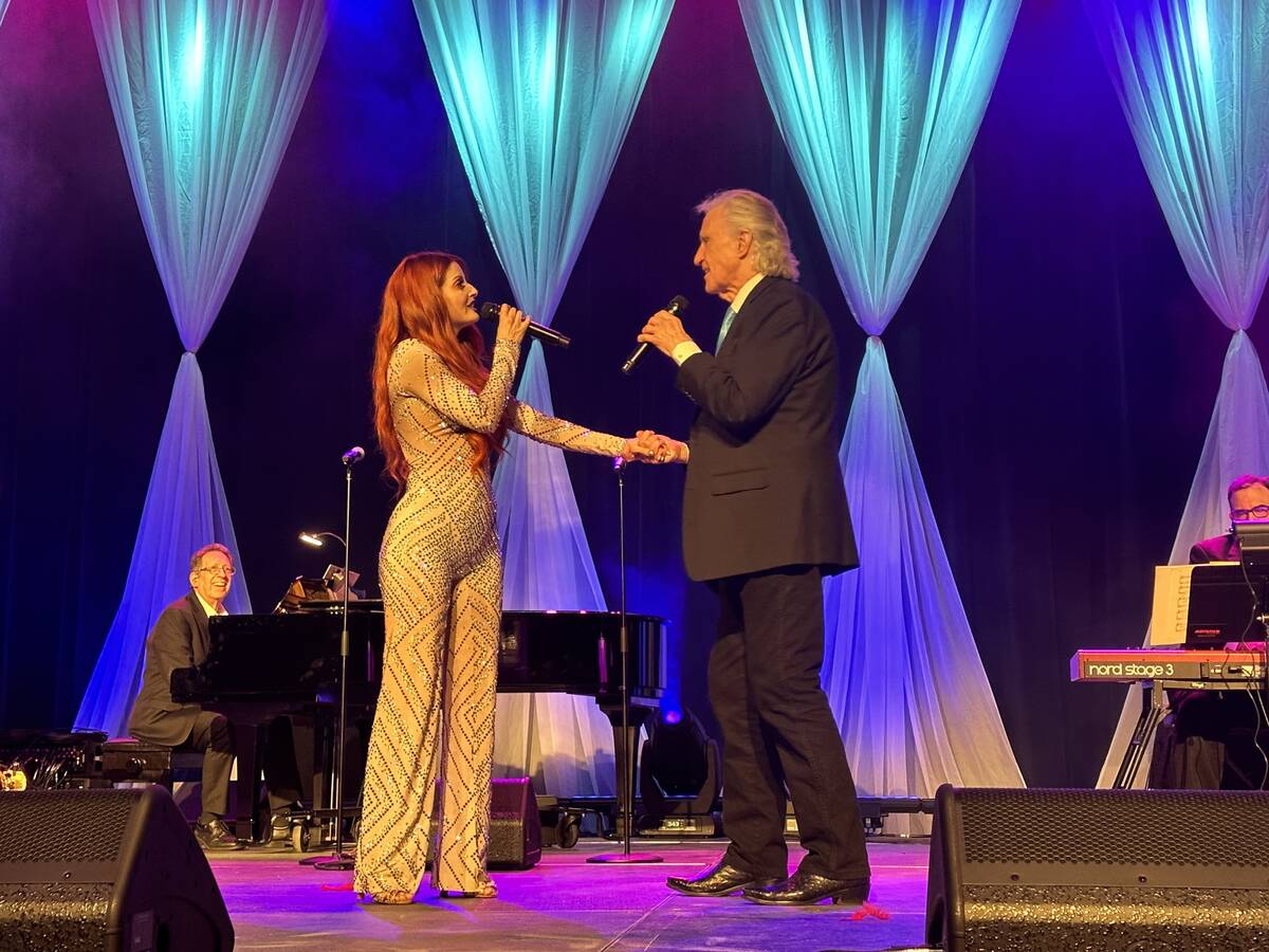 Anne Martinez and Bill Medley perform during a wedding vow-renewal ceremony for nearly 300 coup ...