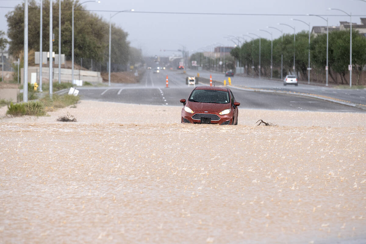 A vehicle is stranded in flash flood waters near the intersection of West Pyle Avenue and South ...