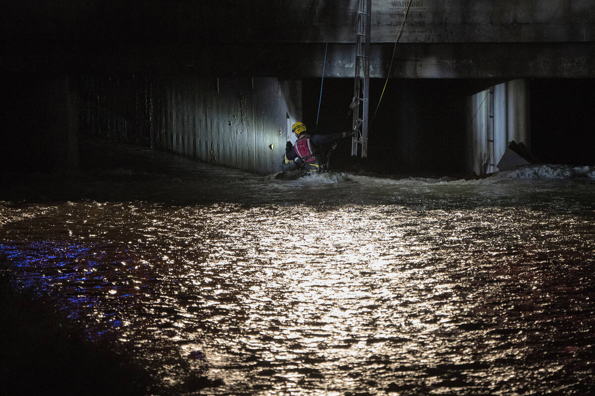 A Clark County Fire Department official searches for a man who was trapped in floodwaters in a ...