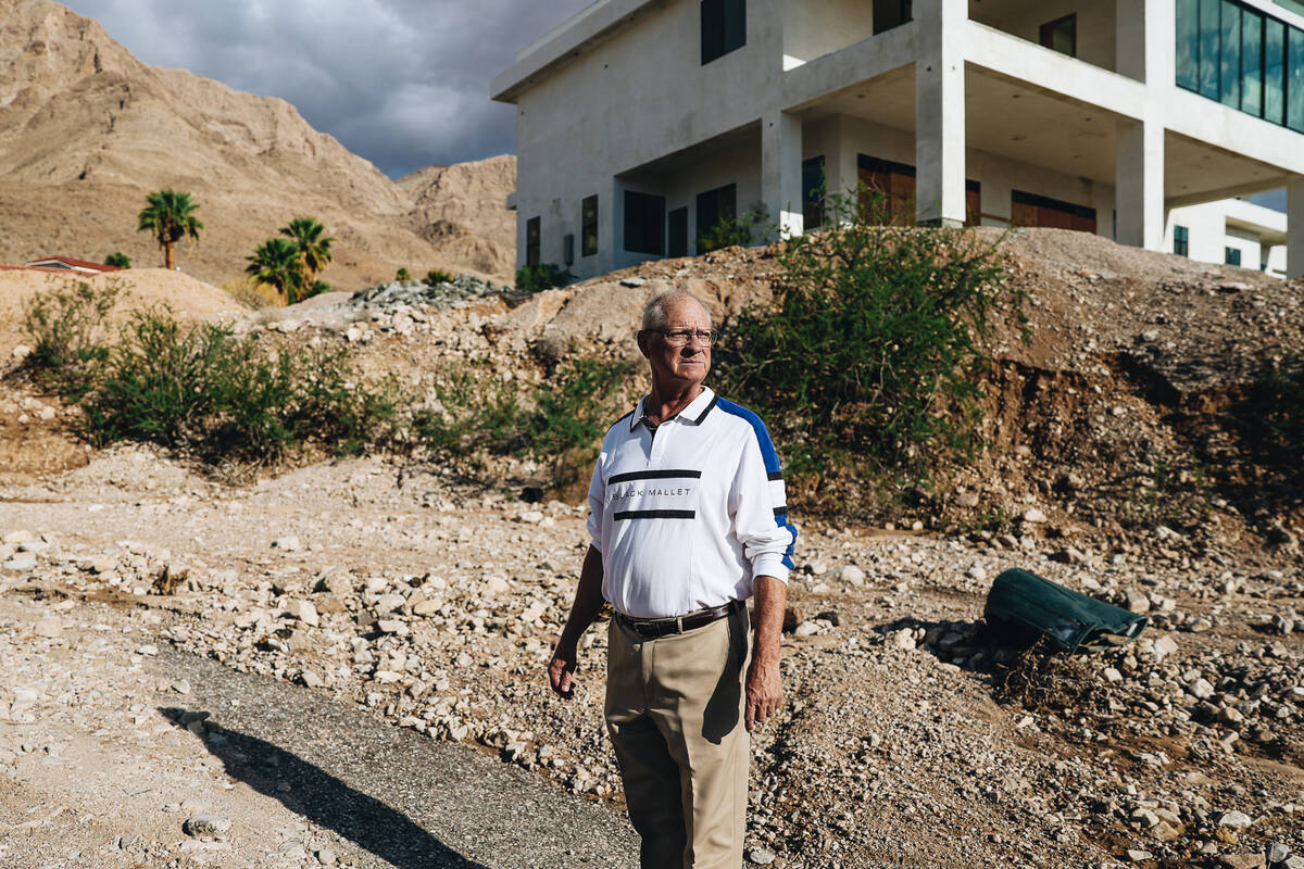 Chuck Muth looks at the damage around his neighborhood outside of Frenchman Mountain on Sunday, ...