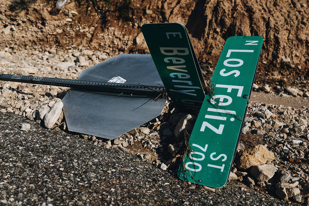 A road sign lays on the ground after being knocked by flood waters on Sunday, Sept. 3, 2023, in ...