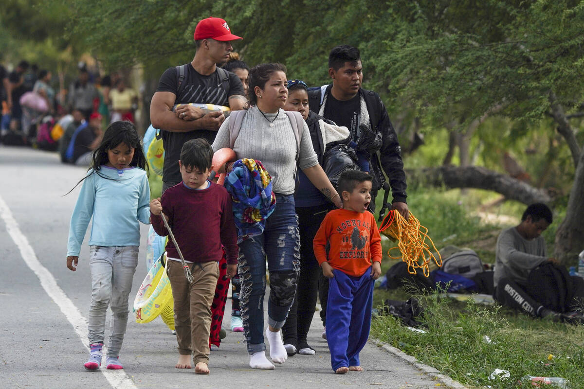 Migrants arrive to the Mexican side of the bank of the Rio Grande river in Matamoros, Mexico, T ...