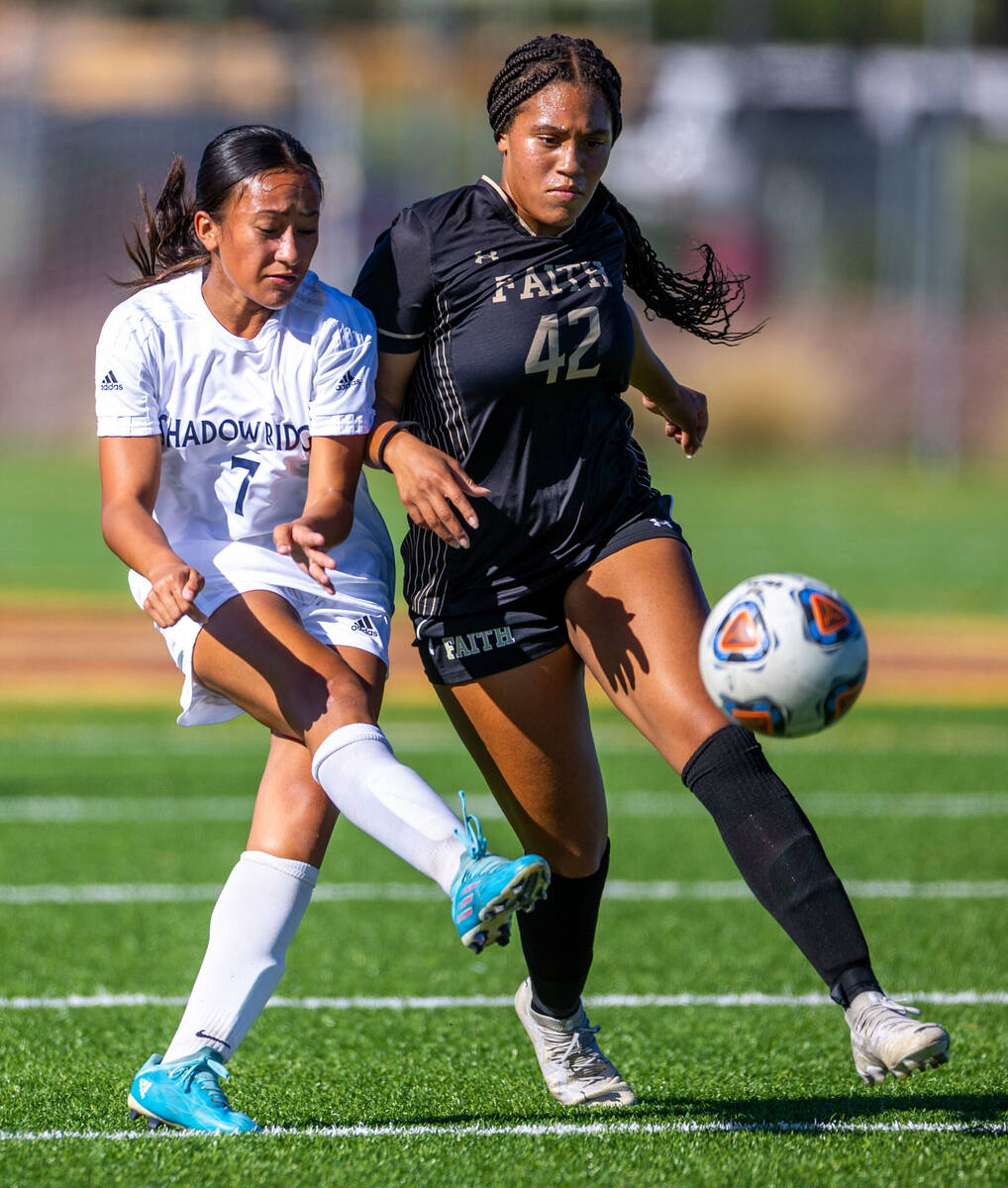 Shadow Ridge midfielder Carmen Loo (7) kicks the ball past Faith Lutheran defender Jailynn Henr ...