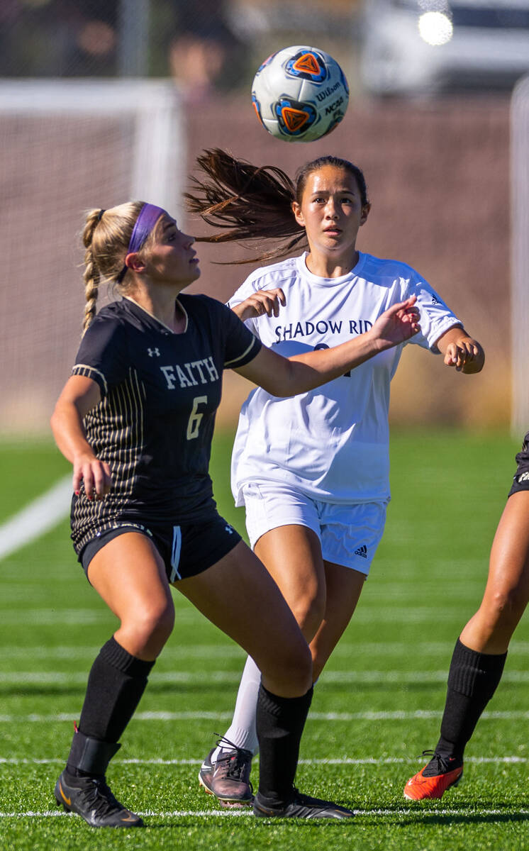 Faith Lutheran defender Jaycee Phillips (6) eyes the ball with Shadow Ridge midfielder Leighann ...