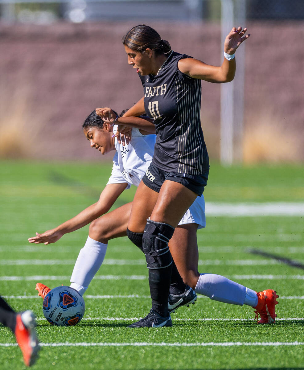 Shadow Ridge midfielder Natalia Nuno (4) fights for the ball while pushed by Faith Lutheran mid ...