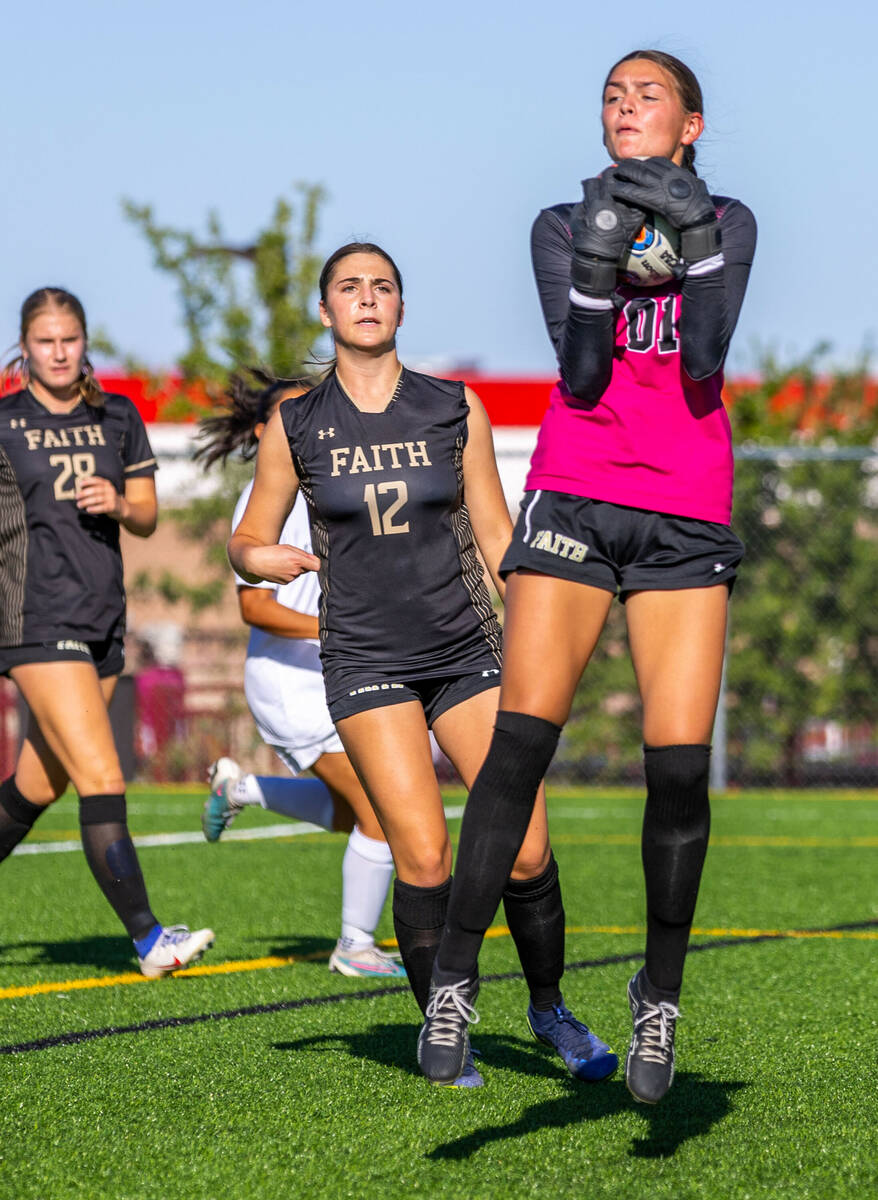 Faith Lutheran goalkeeper Demi Gronauer (01) grabs a shot on goal against Shadow Ridge during t ...