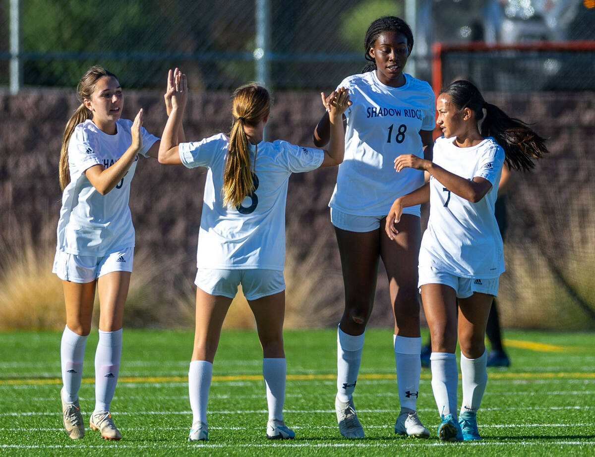 Shadow Ridge forward Liliana Arechiga (18) and teammates celebrate a goal against Faith Luthera ...