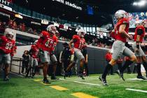 UNLV football players take to the field for their season opener against Bryant at Allegiant Sta ...