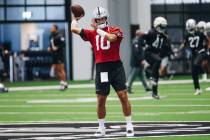 Raiders quarterback Jimmy Garoppolo throws the ball to a teammate during practice at the Interm ...