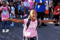 Second-grader Janiya Doebine sees her teacher during the annual “Welcome Back to School” ev ...