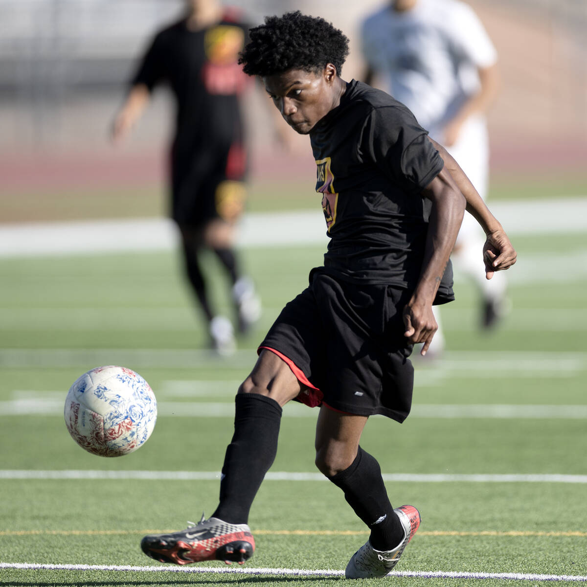 Las Vegas' Jordan Brown (32) kicks before scoring a goal during a boys high school soccer game ...