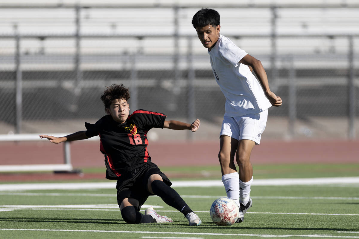 Las Vegas' Israel Pelaez Jr. (16) slide tackles Sunrise Mountain's Gael Luna-Cinto (8) during a ...