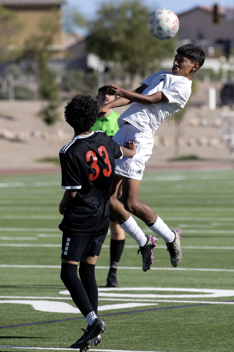 Sunrise Mountain's Jeremiah Espana-Avendano (7) jumps for a header over Las Vegas' Giovanni Her ...