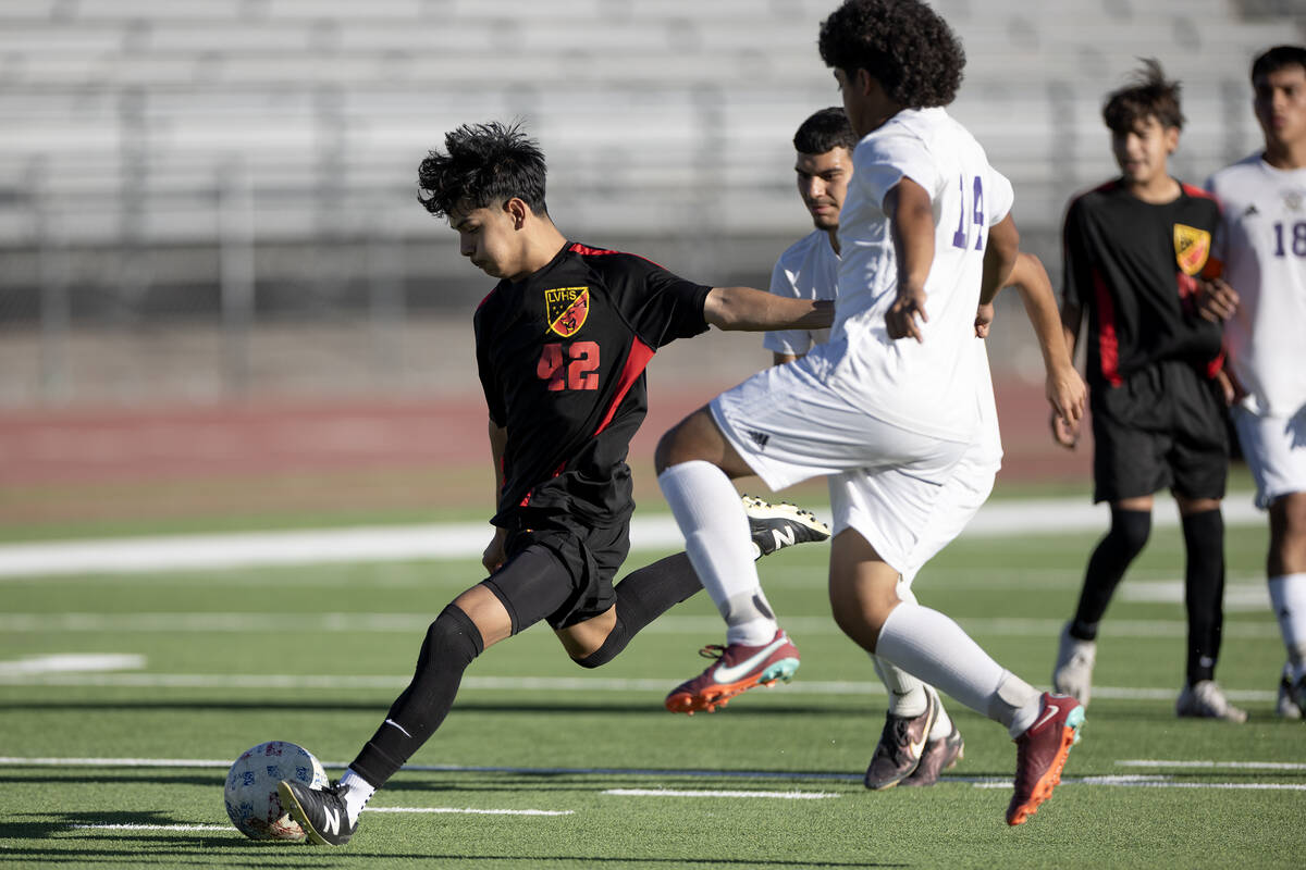 Las Vegas' Lex Madrigal (42) attempts a goal while Sunrise Mountain's Edgar Ceron Rodriguez (14 ...