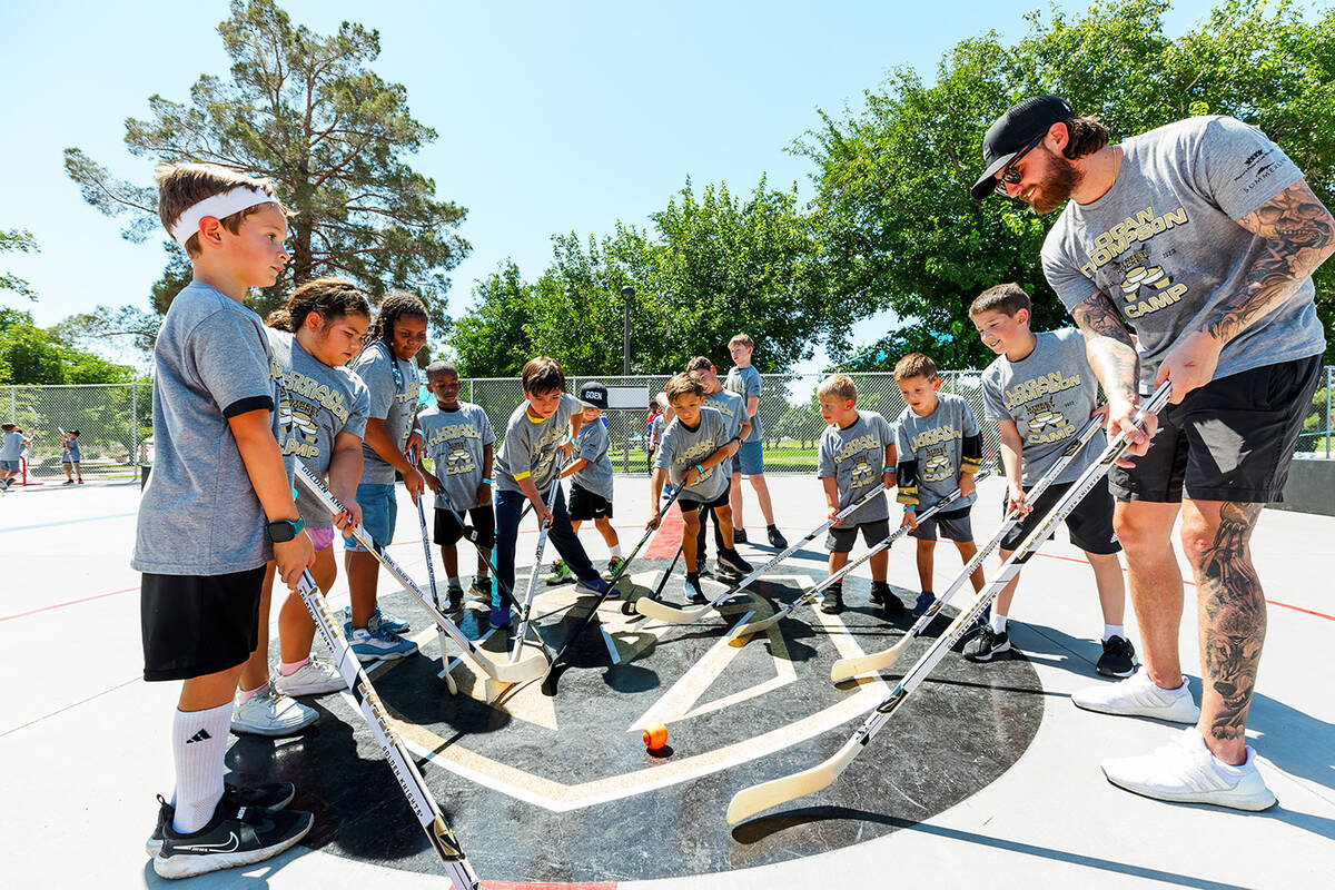Vegas Golden Knight goalie Logan Thompson gives camp participants a few tips during the Aug. 26 ...