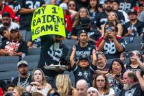 Fans hold a sign in the stands during the half in a first preseason NFL game with the Raiders a ...