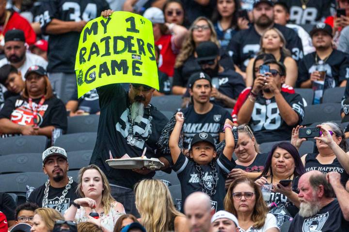 Fans hold a sign in the stands during the half in a first preseason NFL game with the Raiders a ...