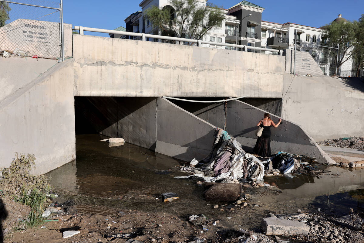 Becky, who declined to give her last name, makes her way into a flood control tunnel under Univ ...