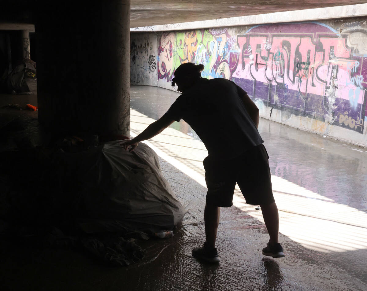 A.J., who declined to give his last name, checks out debris in the flood control tunnel where h ...
