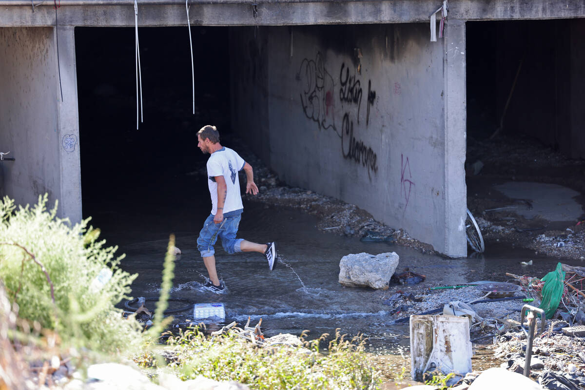 A person walks past flood channel tunnels under Palos Verdes Street east of the Strip in Las Ve ...