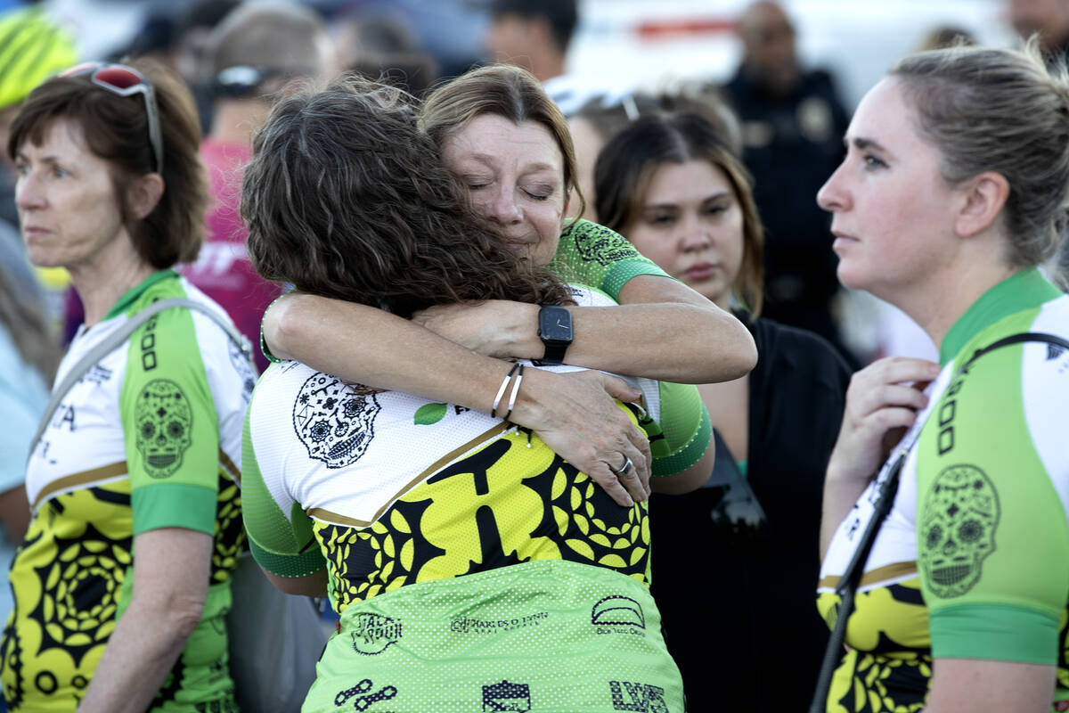 Angela Ahmet, center right, hugs a friend during a memorial for Andreas Probst, a cyclist who w ...