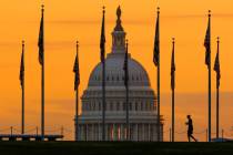 FILE - The U.S. Capitol Building looms behind flags on the National Mall in Washington Nov. 7, ...