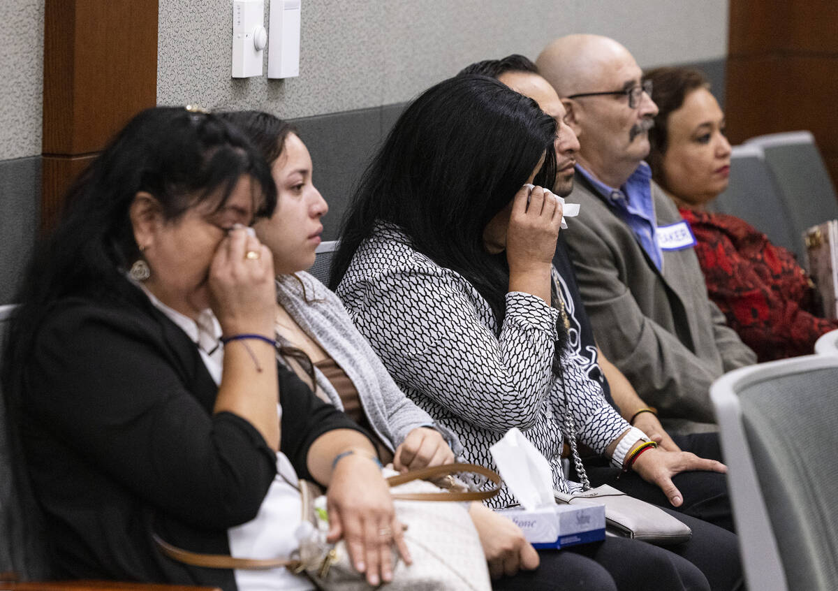 Alberto Sanchez, far right, the father of shooting victim Alberto Sanchez-Delatorre, attends wi ...