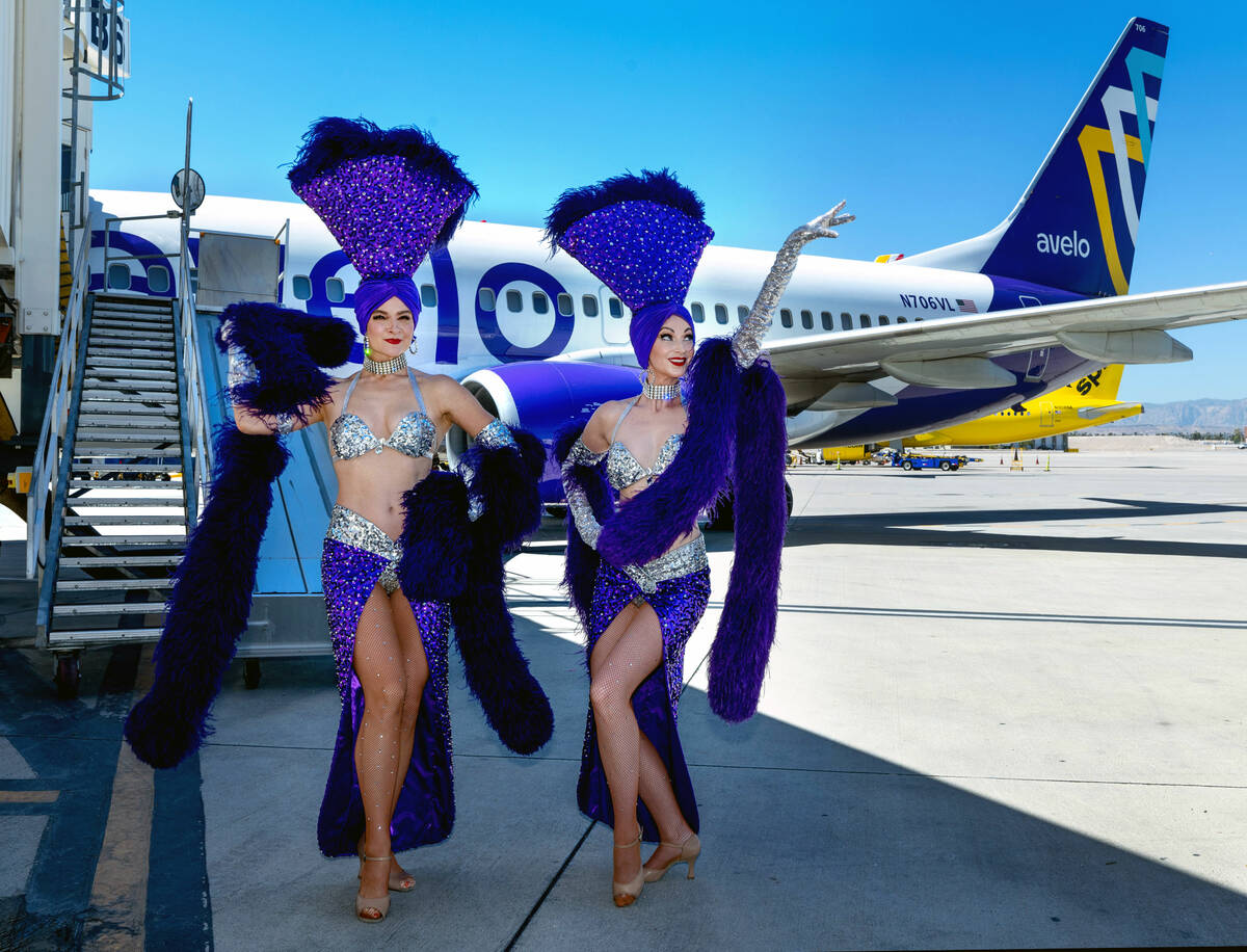 Showgirls Tara Taylor, left, and Sisha Stowell pose on the tarmac as Avelo Airlines begins four ...
