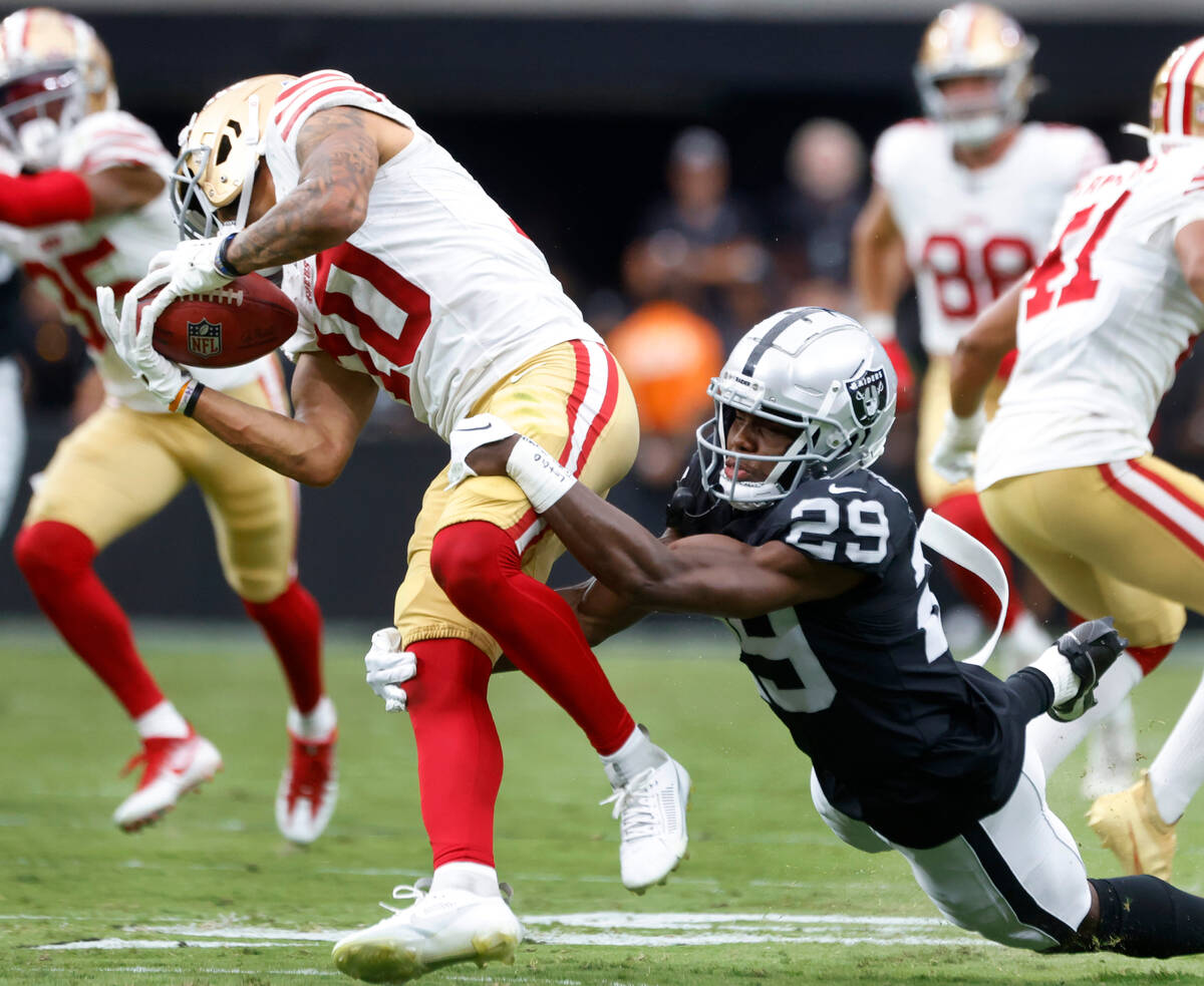 The San Francisco 49ers wide receiver Ronnie Bell (10) tries to avoid a sack from Raiders corne ...