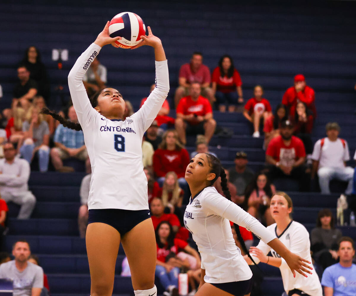 Centennial’s Kassandra Tuiasoa sets the ball for Aliah Williams (15) to spike during a v ...