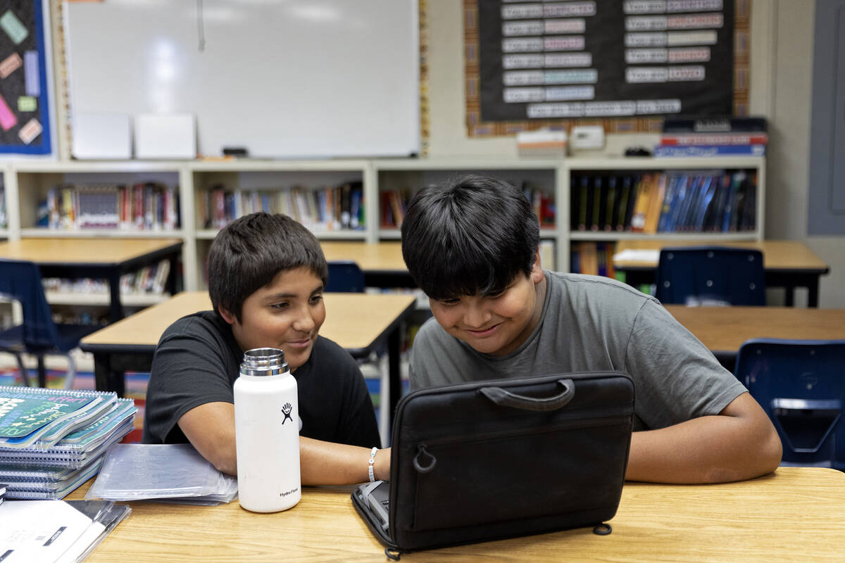 Seventh graders Stryker Anderson, left, and Xavion Jim-Fisher, do homework after school at the ...