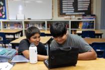 Seventh graders Stryker Anderson, left, and Xavion Jim-Fisher, do homework after school at the ...